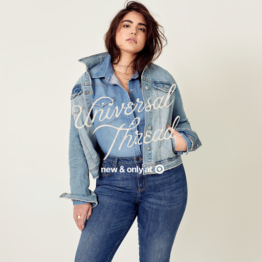 Adult female wearing denim jacket and jeans in a studio shot, posing for a fashion advertisement with 'Universal Thread' text overlay.