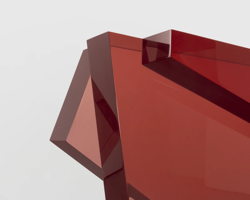 Abstract red geometric shapes with glossy texture against a light gray background, minimal design, studio photography.