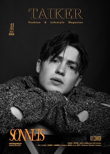 Magazine cover featuring a young adult with dark hair, wearing a distressed sweater, set against a dark backdrop and graphic text.