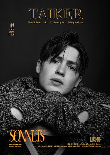 Magazine cover featuring a young adult with dark hair, wearing a distressed sweater, set against a dark backdrop and graphic text.