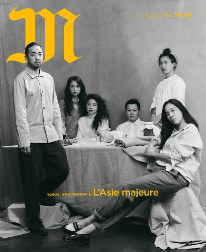 Editorial fashion shot features six Asian adults seated and standing around a table in white clothing. Magazine cover with text overlay.