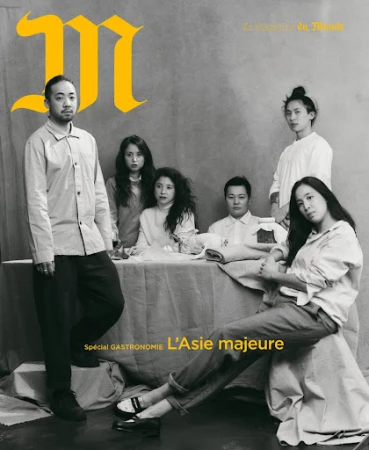 Editorial fashion shot features six Asian adults seated and standing around a table in white clothing. Magazine cover with text overlay.