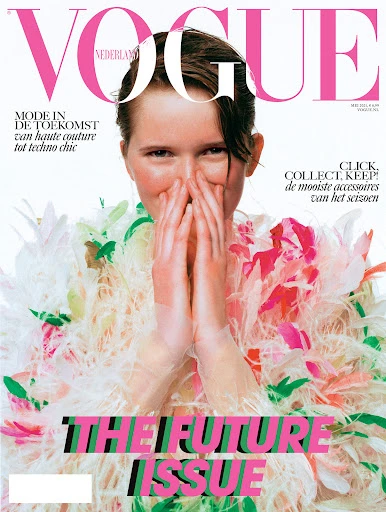 Vogue Nederland magazine cover featuring a person with hands covering their face, wearing a floral and feathery couture outfit. The Future Issue.