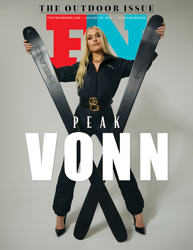 Footwear News cover featuring blonde woman in black outfit, holding skis, black high heels, and designer belt on a light background.