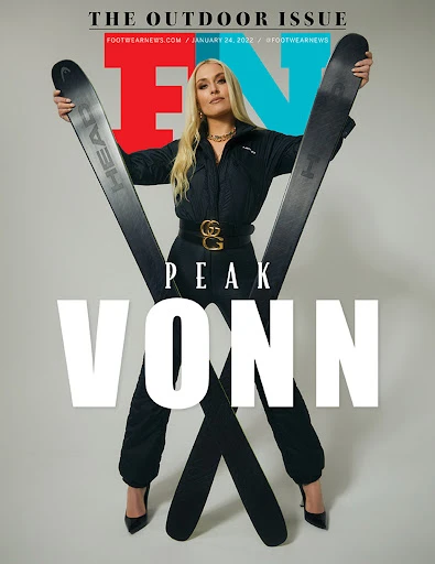 Footwear News cover featuring blonde woman in black outfit, holding skis, black high heels, and designer belt on a light background.