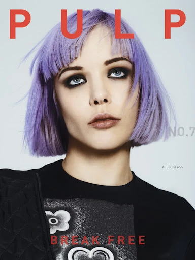 Magazine cover featuring a young woman with purple hair, heavy dark eye makeup, wearing a black graphic t-shirt, and bold 'PULP' text.