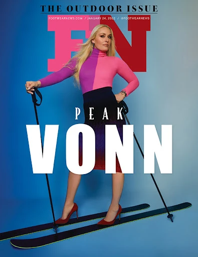 Lindsey Vonn on Footwear News cover poses in colorful top, dark skirt, and heels on skis with ski poles against a blue backdrop.