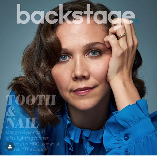 Maggie Gyllenhaal portrait for Backstage magazine cover, wearing a blue frilled shirt, indoors with soft, diffused lighting.