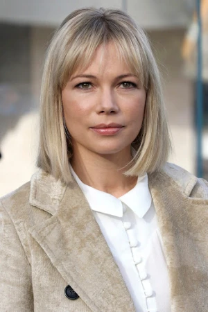 Michelle Williams with blonde bob and bangs wearing cream coat and white collared shirt