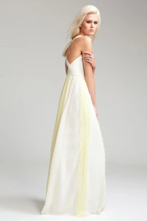 Model with long blonde hair wearing a white and yellow halter gown against a pale grey background.