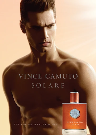 Advertisement for Vince Camuto Solare cologne, featuring a muscular adult male and the fragrance bottle against a warm orange background.