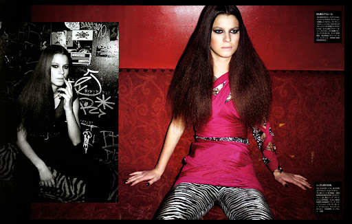Fashion editorial of an adult female model in a pink top and zebra-striped pants sitting against a red wall, with a monochrome inset.