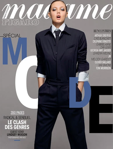 Magazine cover featuring Lindsey Wixson in tailored suit with tie, against a neutral gray backdrop, with the 'Madame Figaro' masthead.