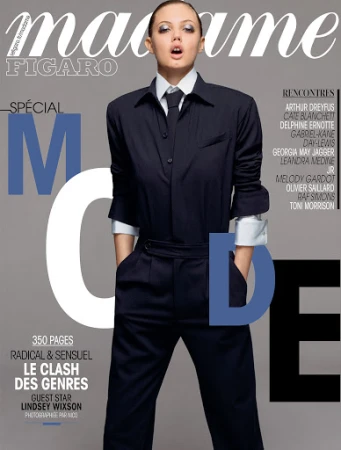 Magazine cover featuring Lindsey Wixson in tailored suit with tie, against a neutral gray backdrop, with the 'Madame Figaro' masthead.