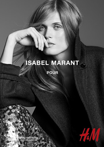 Black and white fashion shot features a fair-skinned model with long blonde hair, wearing a dark jacket and shimmering pants while posing.