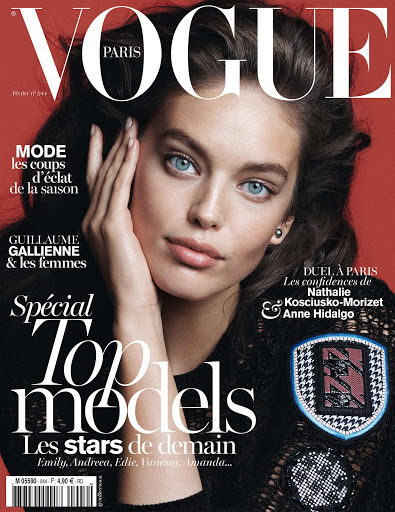 Vogue Paris cover featuring a young adult female model with light skin, light eyes, dark hair, wearing dark clothing, and light makeup.