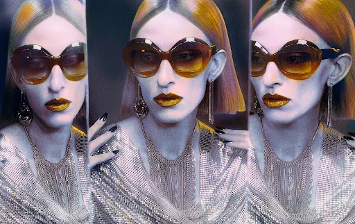 Three identical women in sunglasses and metallic tops. Gold lipstick and shoulder-length blonde hair. Fashion photography with a surreal effect.