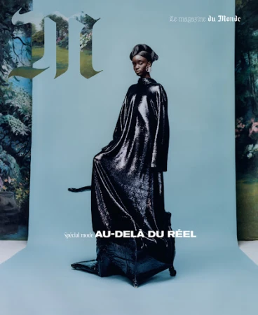 A fashion editorial magazine cover features a Black model in a shimmering black gown against a light blue backdrop with floral elements.