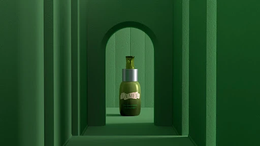 Olive-green bottle of La Mer Renewal Oil set against a matching green tunnel-like backdrop with soft lighting for beauty advertising.