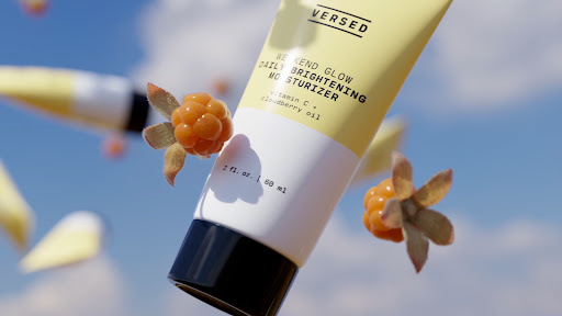 Versed Weekend Glow Daily Brightening Moisturizer tube floating with cloudberries against a blue sky with soft, blurred clouds.