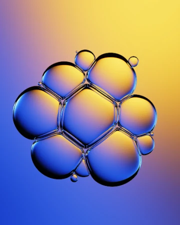 Macro shot of interconnected soap bubbles shimmering with blue and yellow iridescence against a soft gradient background.