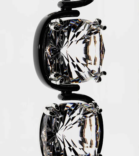 Macro shot of a black metal jewelry display featuring two clear faceted gemstones suspended in a white background, highlighting geometric shapes.