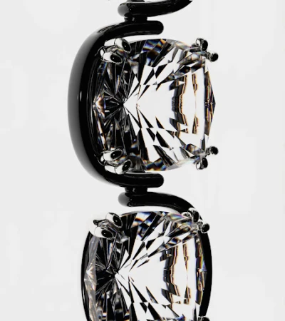 Macro shot of a black metal jewelry display featuring two clear faceted gemstones suspended in a white background, highlighting geometric shapes.