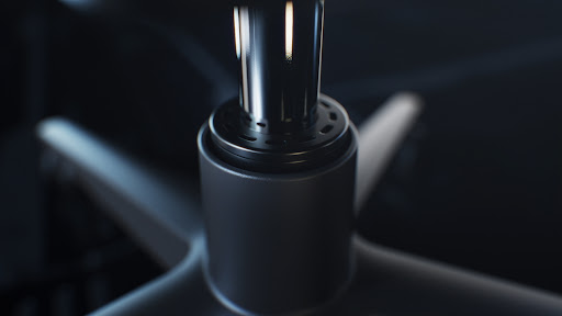 Close-up of the base and support column of an office chair, showcasing its gray and black metal construction.