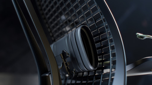 Close-up of a futuristic, metallic, oval-shaped structure with a detailed grid pattern and smooth, rounded edges against a dark backdrop.