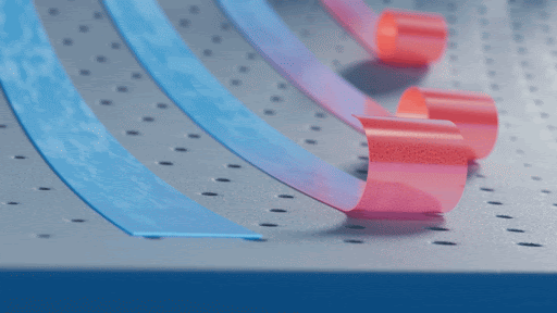 Abstract motion graphic featuring blue and pink ribbons gracefully curving across a perforated grey surface in a visually dynamic composition.