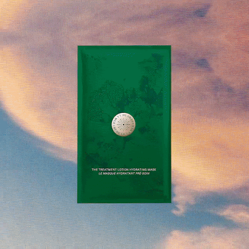 Green hydrating mask packet features centered logo in a light blue and peach sky. The product is illuminated with studio lighting.