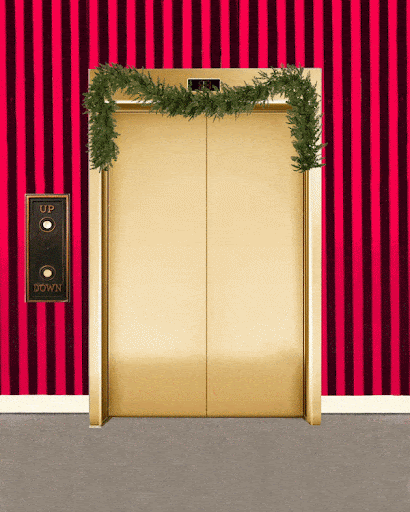 Gold elevator doors are adorned with Christmas garland in a festive scene featuring striped wallpaper and an elevator call button.