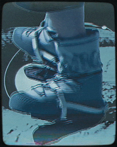 Close-up of worn blue and white boots with laces, set against a blurred background, showcasing texture and minimalist style.