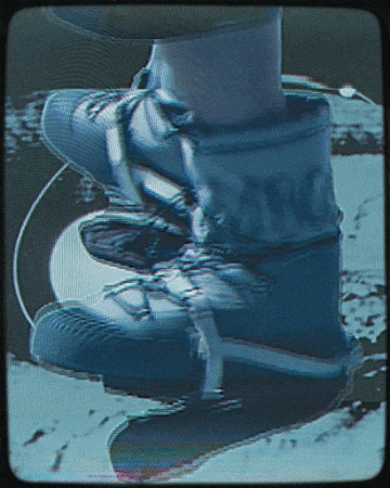 Close-up of worn blue and white boots with laces, set against a blurred background, showcasing texture and minimalist style.