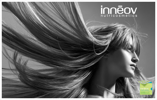 Black and white profile shot of a woman with flowing blond hair and a product box, captured in a studio setting.