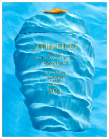 Close-up studio shot of Shiseido Ultimate Sun Protection Lotion bottle, SPF 50+, set against a light blue water-like background.