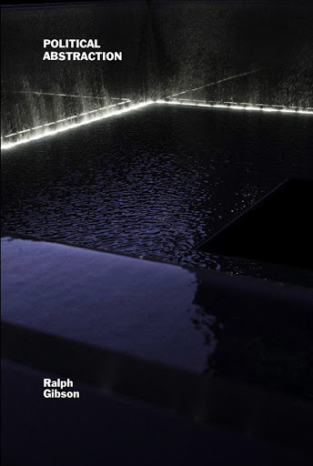 Abstract shot of water and stone illuminated by soft light, creating a serene, modern scene. Dark, reflective surfaces give a minimalist feel.