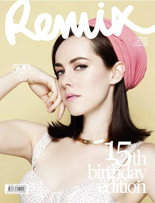 Magazine cover featuring a woman with dark hair and a pink headscarf, wearing a gold choker, against a yellow background. 