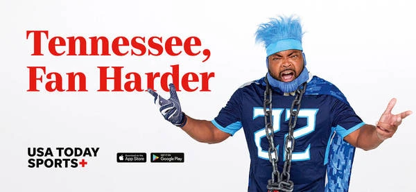 Enthusiastic sports fan in team colors with chains, USA Today Sports+ ad promoting Tennessee fandom with a plain studio background.