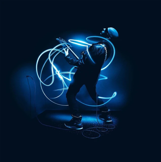 Musician in silhouette playing an electric guitar with blue light trails on a dark blue background.