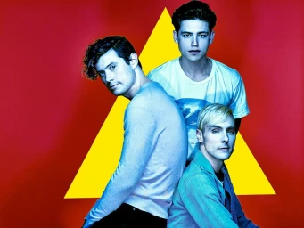 Portrait of three men against a red background with a large yellow triangle by photographer Joseph Cultice.