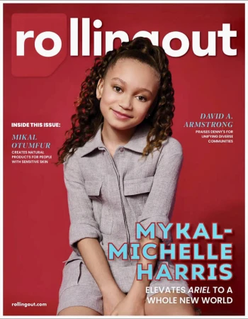 Magazine cover featuring Mykal-Michelle Harris, a young woman with curly hair, wearing a gray jumpsuit, set against a solid red background.