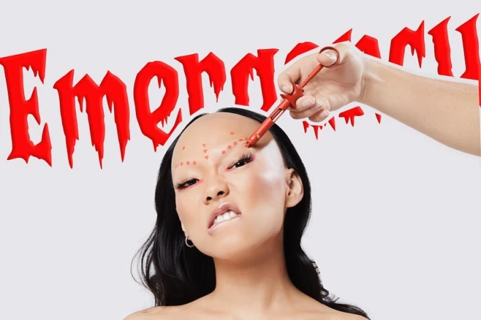 Woman getting cosmetic enhancement with red tool, face marked with red dots, studio shot, red text 'Emergency' background.