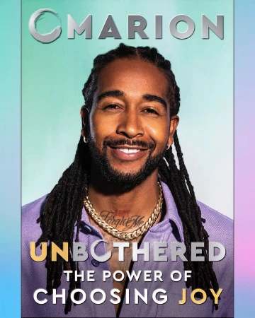 Magazine cover featuring smiling Black man with dreadlocks wearing gold chain and purple shirt, text "Unbothered the power of choosing joy".