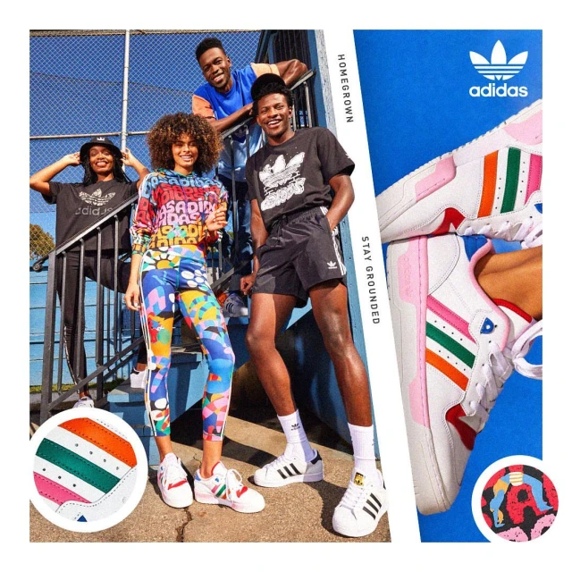 Four young adults wearing Adidas apparel and shoes pose on a sunny day, while cropped shoes with colorful stripes are in the foreground.