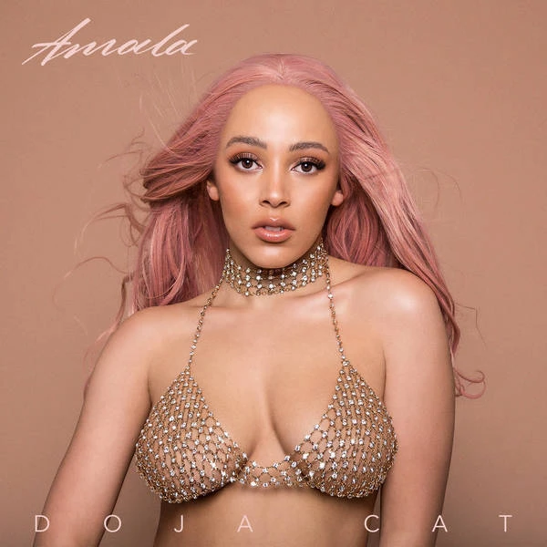 Glamorous portrait of Doja Cat with pink hair, wearing a diamond-studded bikini top and necklace against a neutral background for her album cover.