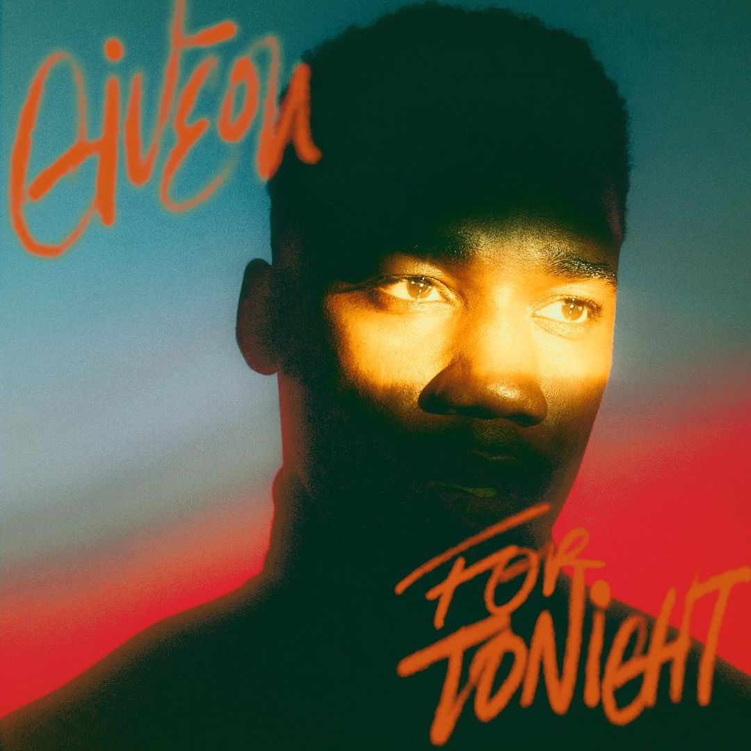 Portrait of a black man with short hair against a gradient background. He is illuminated by warm light. Album cover art.