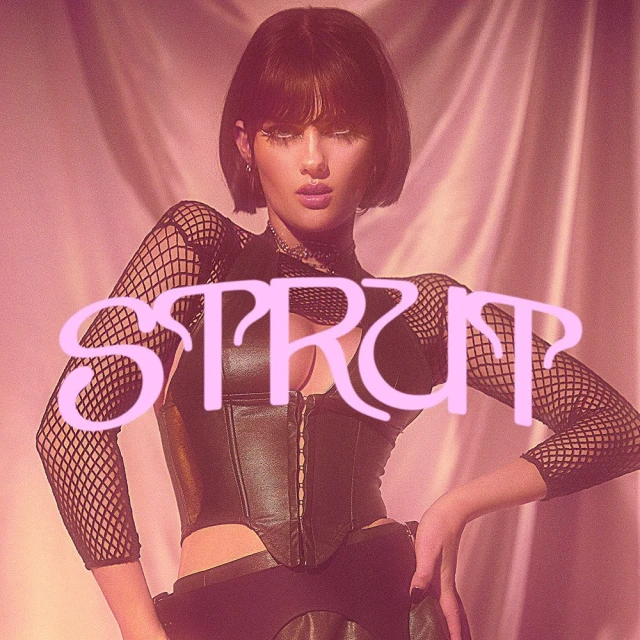 Portrait of a woman with dark hair in a black corset and fishnet sleeves with 'STRUT' text overlayed on a pink background.