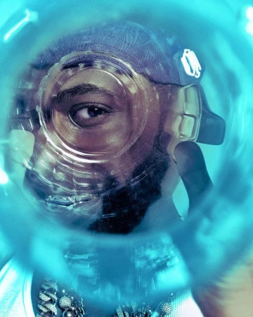 Close-up portrait of a person looking through a transparent plastic water bottle, showcasing a creative perspective and blue tones.