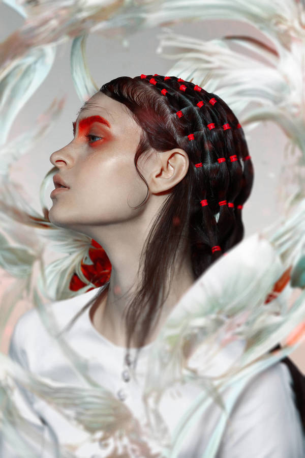 Profile of woman with red eyeshadow and beads in hair against an abstract floral background in a beauty and fashion setting.